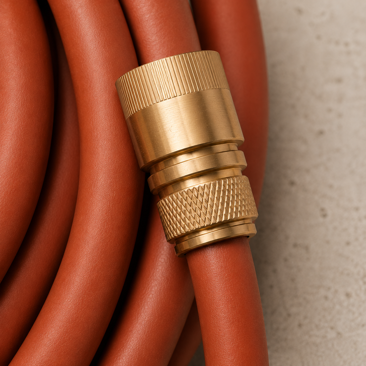 Close-up of the Limited Edition Rust Hybrid Garden Hose with solid brass quick connector fitting