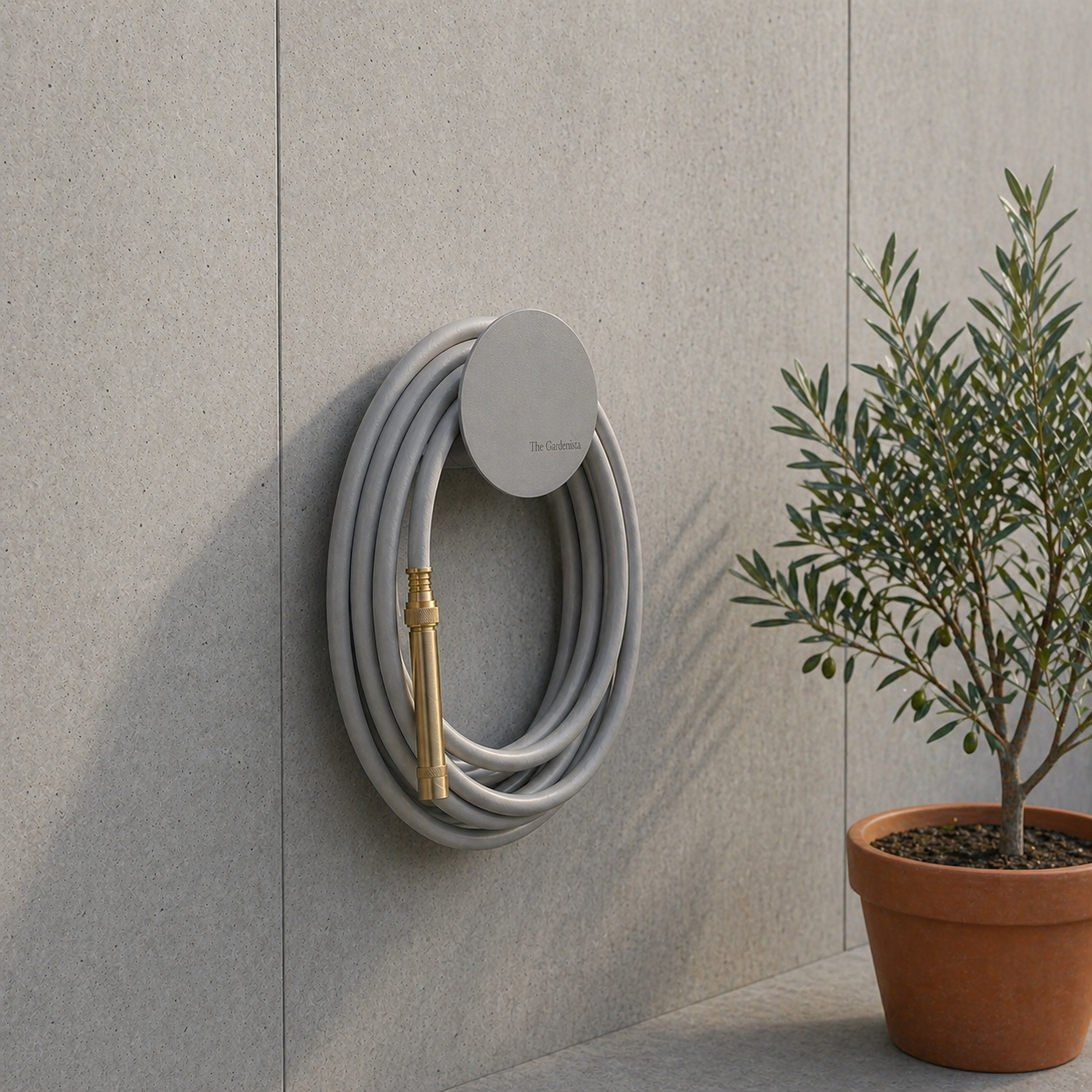 small-grey-hose-holder-wall-mounted-concrete-olive-gardenista.jpg